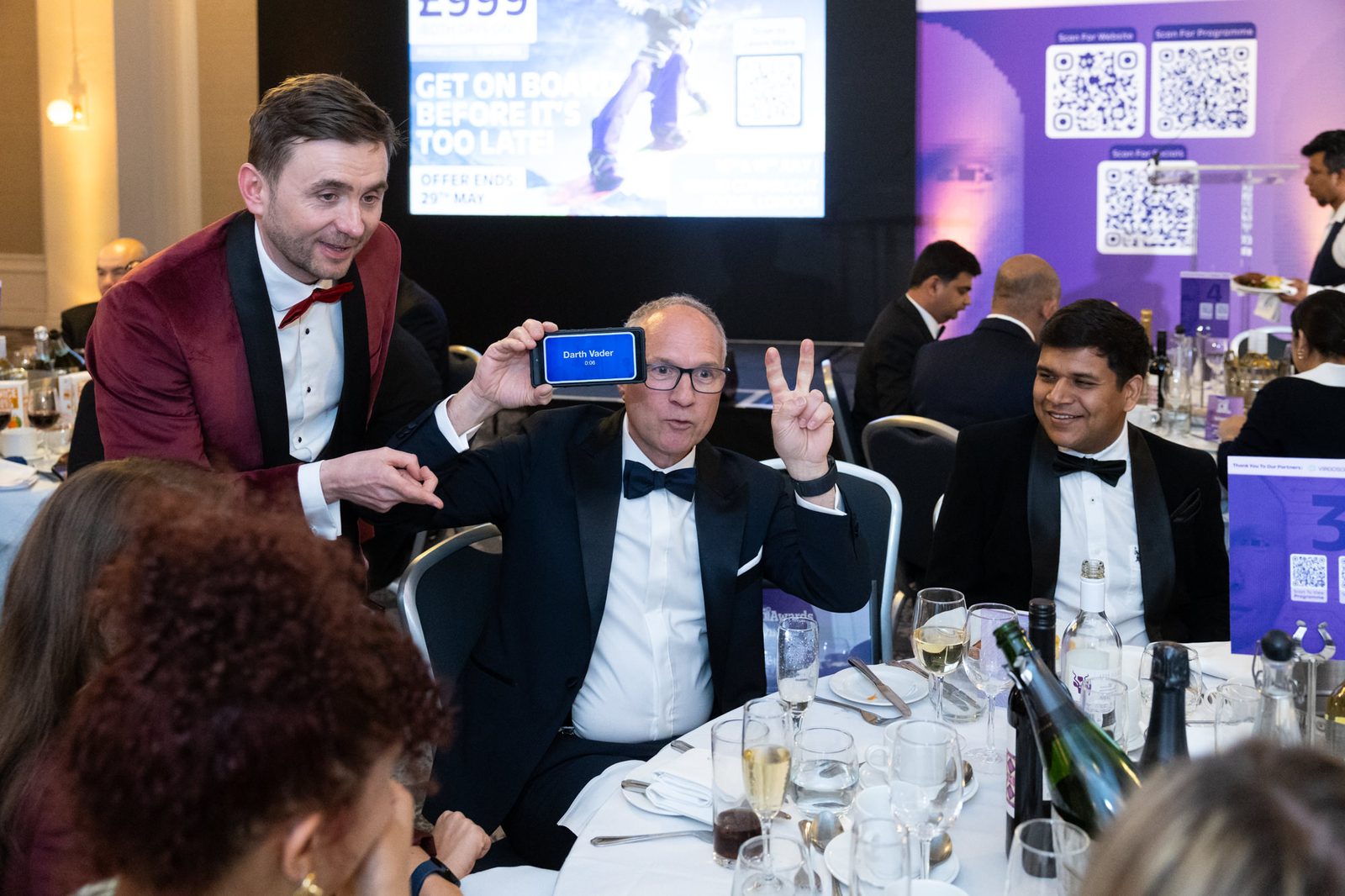 Kevin Durham running an interactive Heads Up game with guests during a black-tie corporate awards dinner