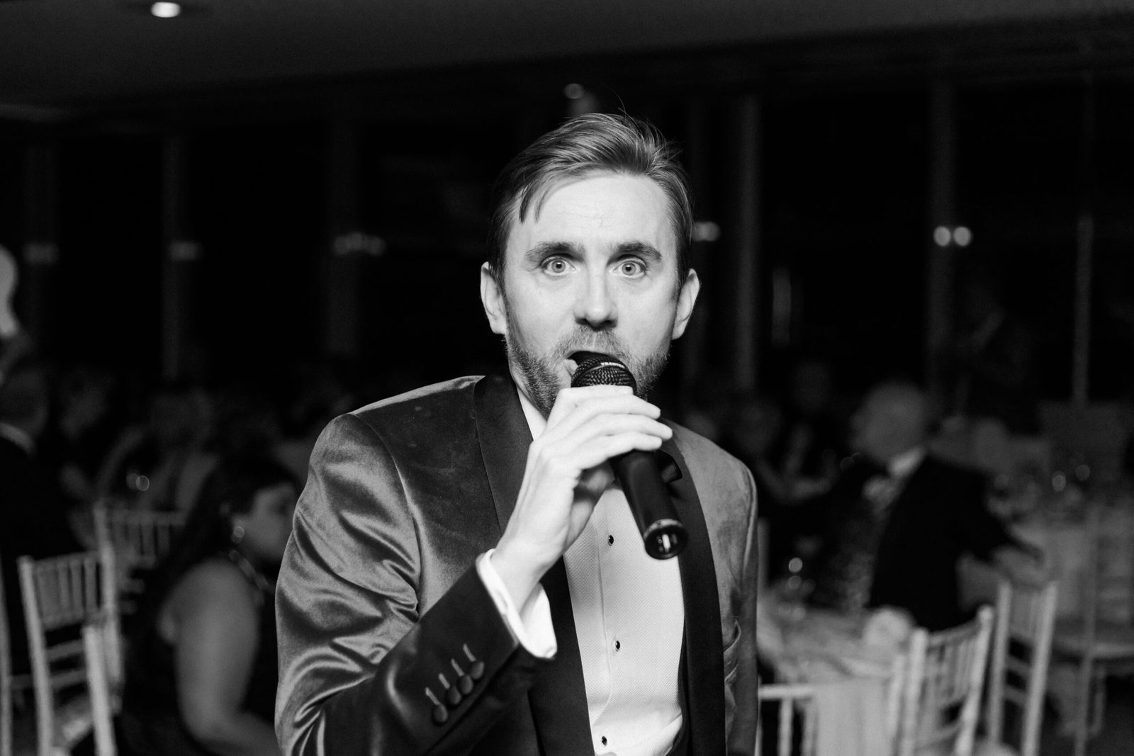 Kevin Durham on the microphone at a black-tie fundraiser