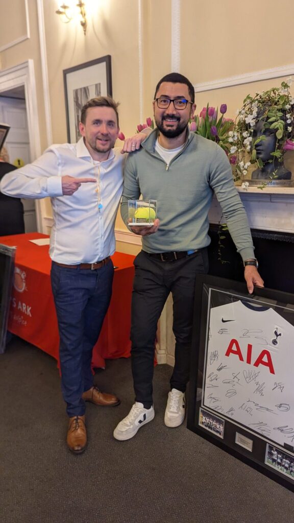 A guest collecting a signed shirt quiz prize
