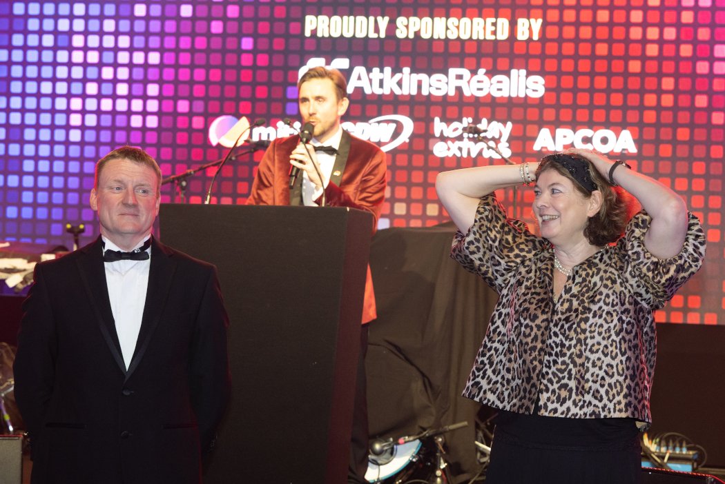 Kevin Durham running a heads-or-tails game with guests at a black-tie charity ball